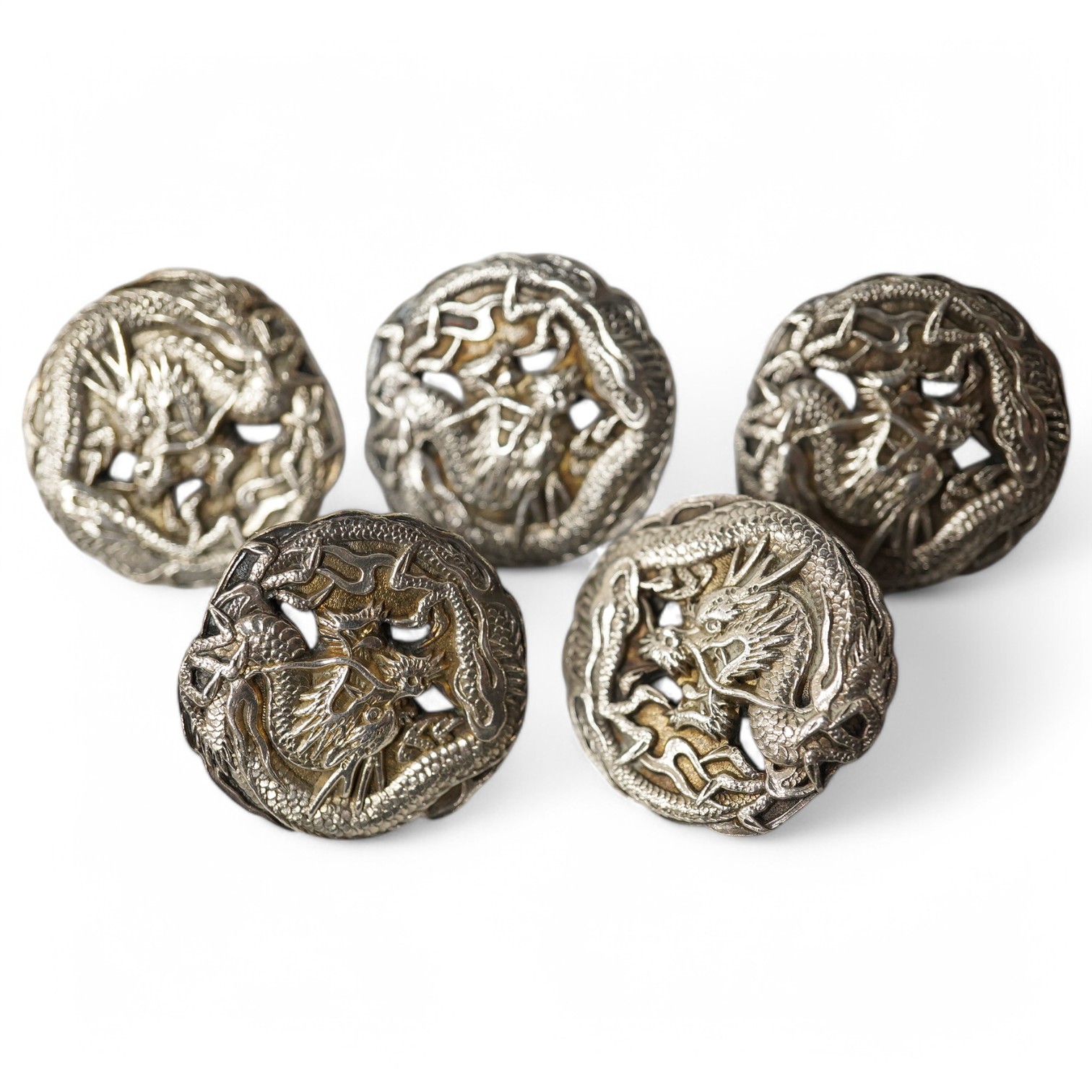 A set of 5 early 20th century Japanese white metal buttons decorated with dragons, 24mm. Condition - good